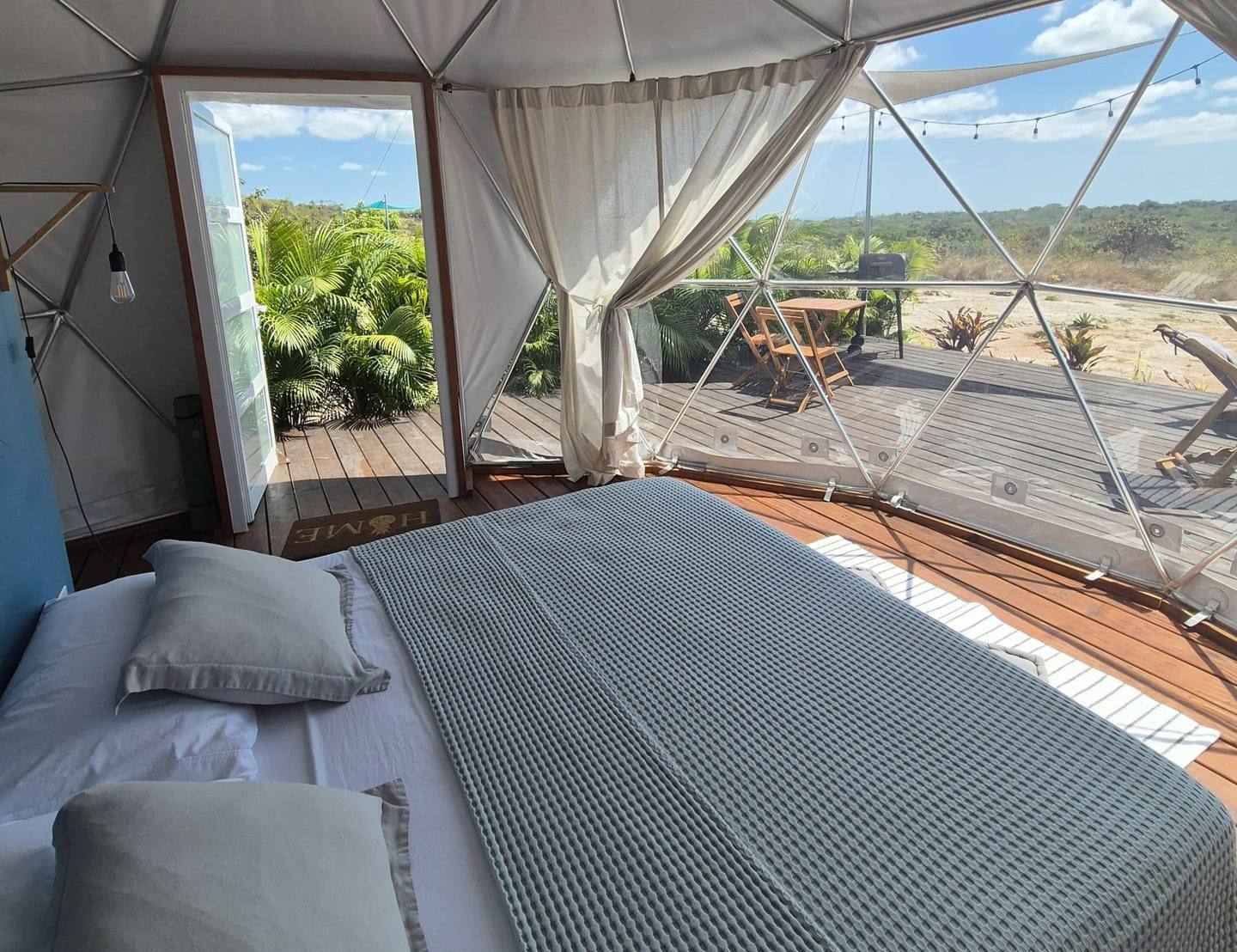 Vue extérieure d'un dôme géodésique transparent du Prana Home entouré par la forêt tropicale au Panama